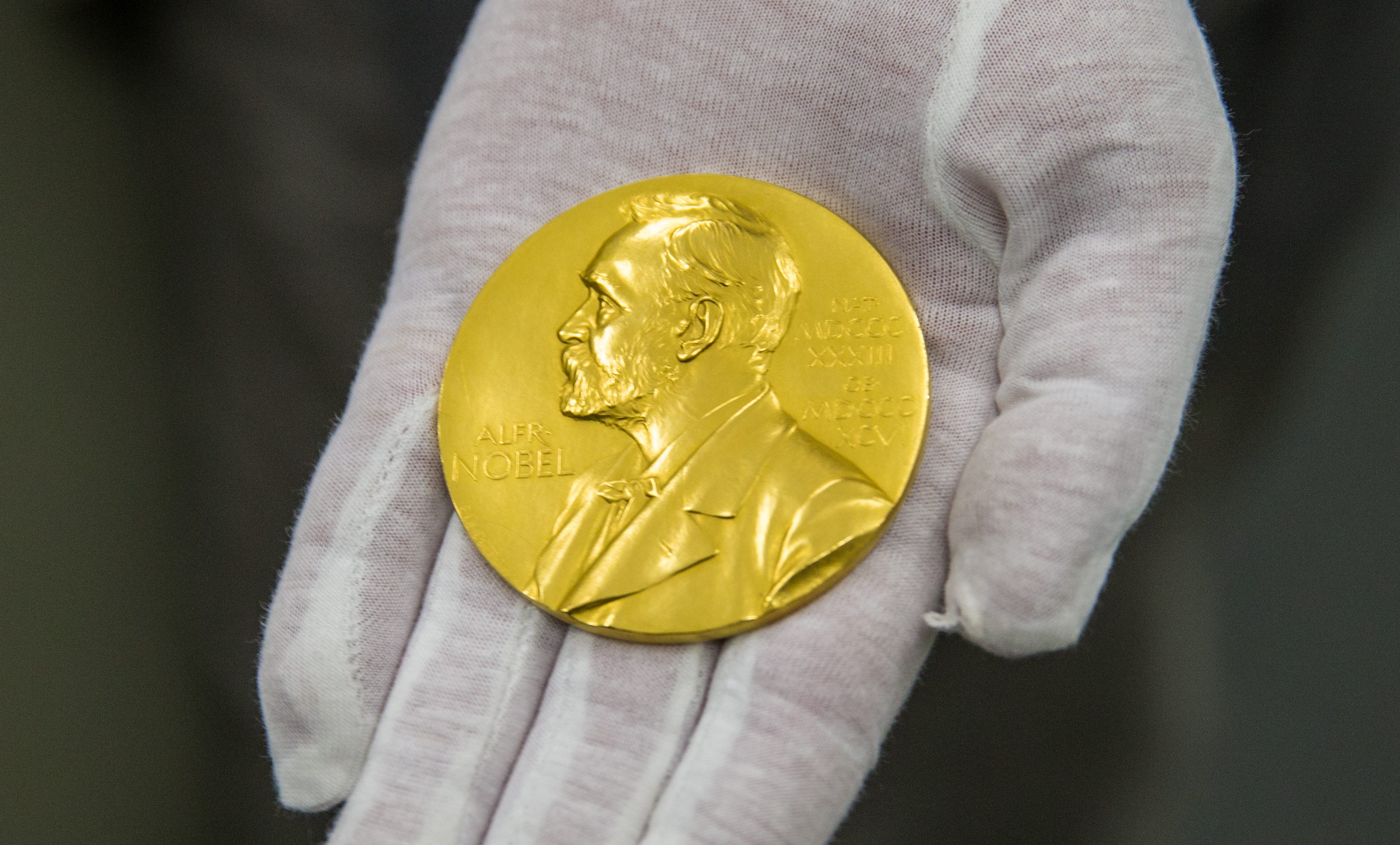 The Nobel Prize medal of physicist Ferdinand Braun is presented by Wilhelm Fuessl, director of the archive of the Deutsches Museum, in Munich, Germany, 29 February 2016. (Marc Müller/picture alliance via Getty Images)