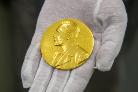 The Nobel Prize medal of physicist Ferdinand Braun is presented by Wilhelm Fuessl, director of the archive of the Deutsches Museum, in Munich, Germany, 29 February 2016. (Marc Müller/picture alliance via Getty Images)