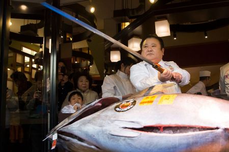 Kiyoshi Kimura poses with an endangered bluefin tuna before cutting it in front of one of the company's Sushi Zanmai sushi restaurants. He paid a record $3.1 million for a single fish at the annual New Year auction at Tokyo's Tsukiji market. (Photo by Tomohiro Ohsumi/Getty Images)