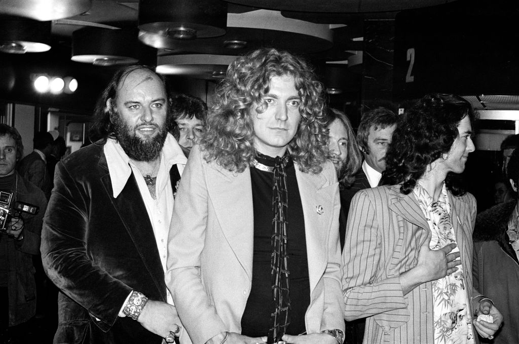 Rock band Led Zeppelin at the UK premier of the concert film 'The Song Remains The Same'. Pictured from left to right, manager Peter Grant, Robert Plant and Jimmy Page, 4th November 1976. (Photo by G Morris/Mirrorpix/Getty Images)