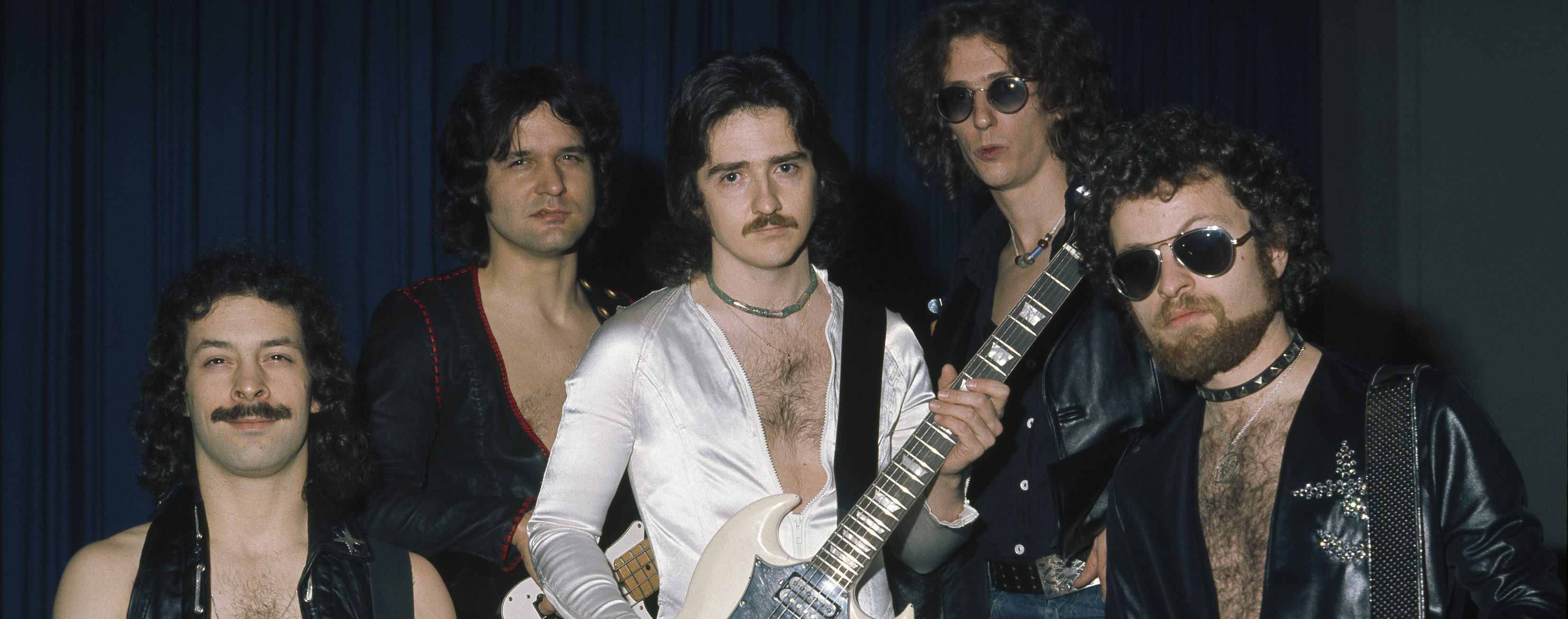 Blue Oyster Cult pose for a group shot, (L-R) Albert Bouchard, Joe Bouchard, Buck Dharma, Allen Lanier, and Eric Bloom on October 27th 1975 in Copenhagen, Denmark. (Photo by Jorgen Angel/Redferns)