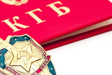 A KGB badge lays on a closed KGB identity book.   (Getty Images)