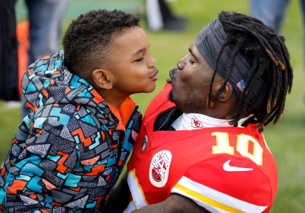 Tyreek Hill teases his son Zev during pregame warmups at Arrowhead Stadium. (David Eulitt/Getty)