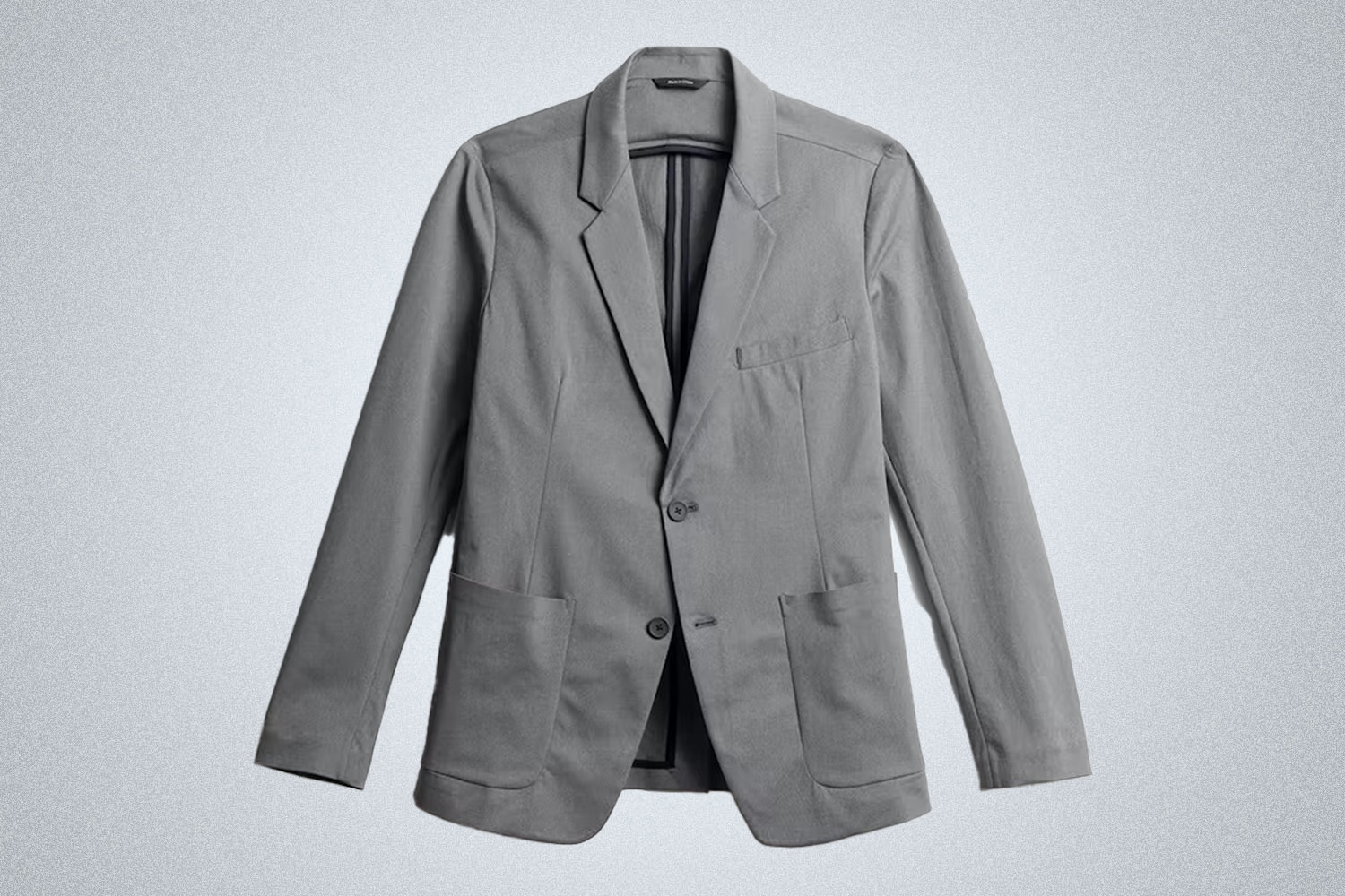 a grey Ministry of Supply travel blazer on a grey background