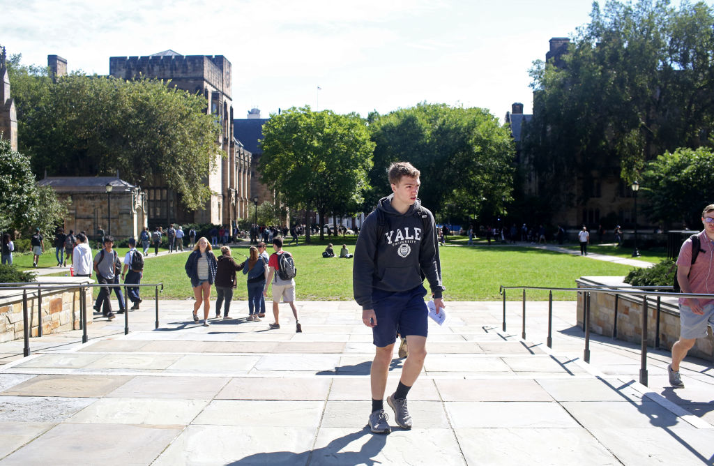 Students walk through the campus of Yale University (Photo by Yana Paskova/Getty Images)