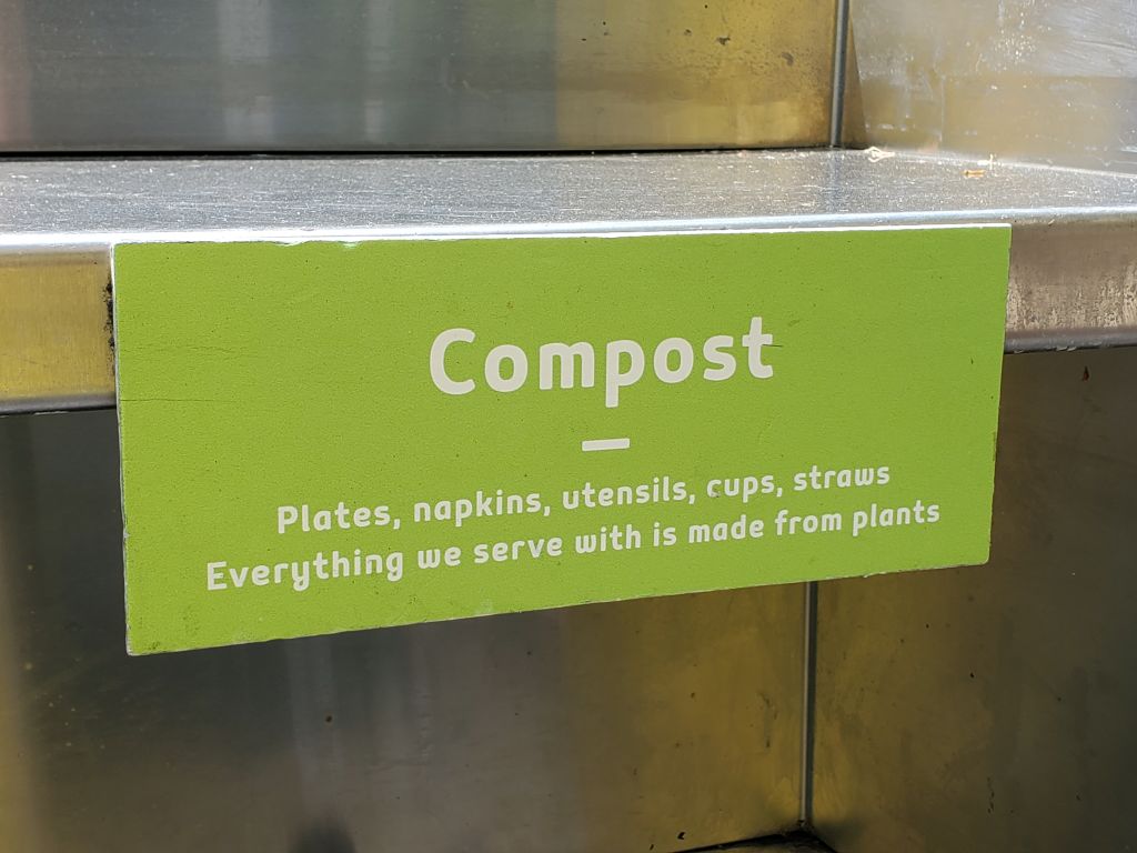 Sign above compost bin in restaurant in Dublin, California, stating that all silverware and other serving ware is made from compostable materials, July 30, 2019. (Photo by Smith Collection/Gado/Getty Images)