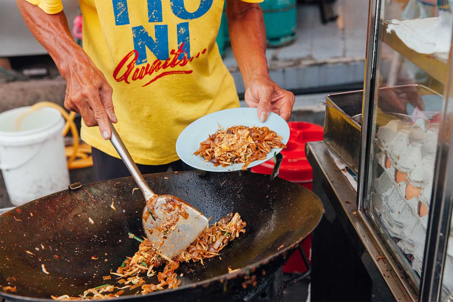 George Town, Malaysia - March 22, 2016: Hands of the senior man cooking kway teow noodles in asian wok at the Kimberly Street Food Night Market on March 22, 2016 in George Town, Penang, Malaysia. (Getty Images)