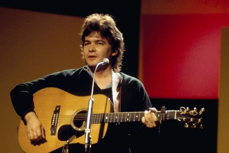 Musician John Prine on stage, circa 1970-1975. (Photo by Tony Russell/Redferns/Getty Images)