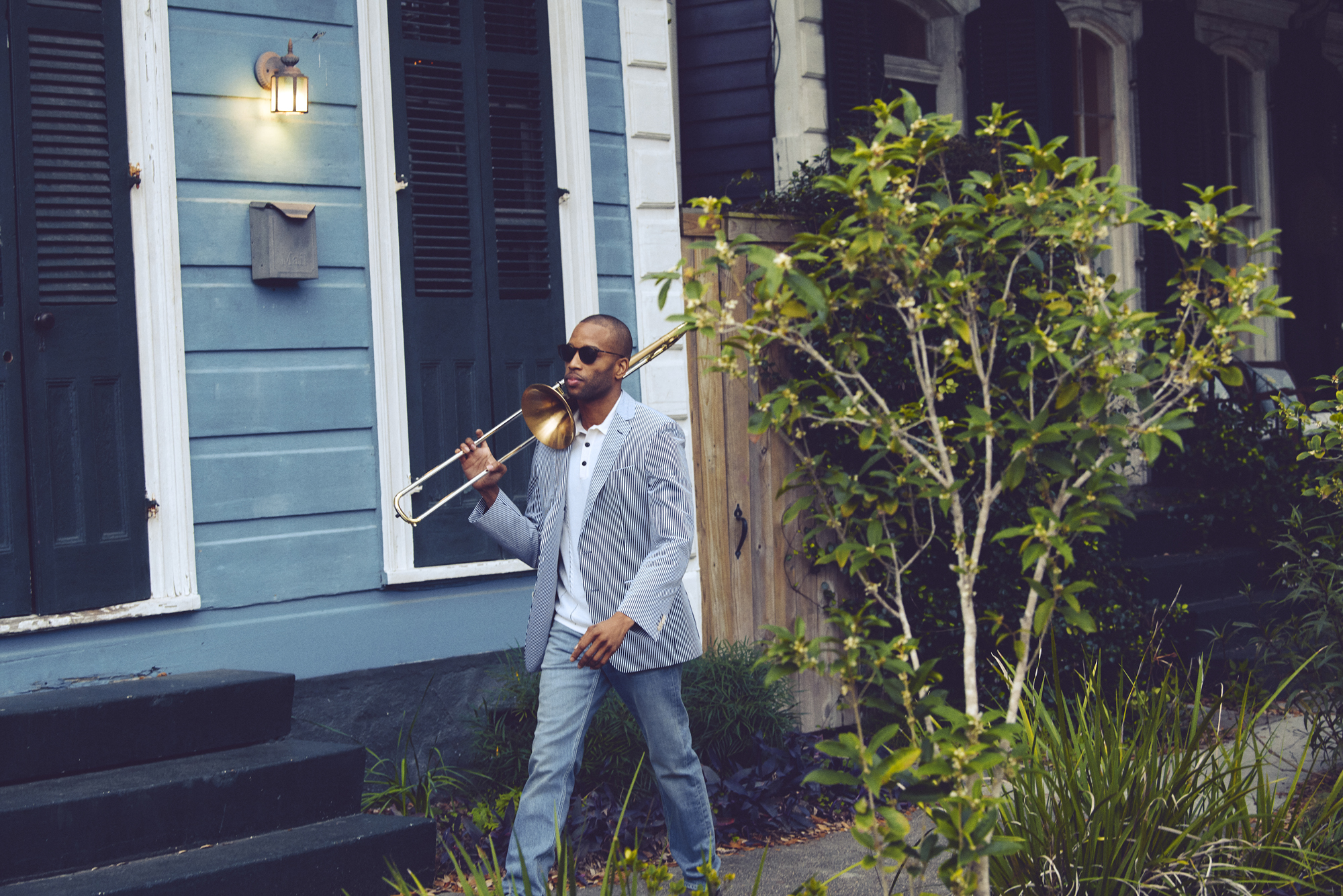 Trombone Shorty strolling through Treme wearing Salvatore Ferragamo, Rag & Bone, and BOSS