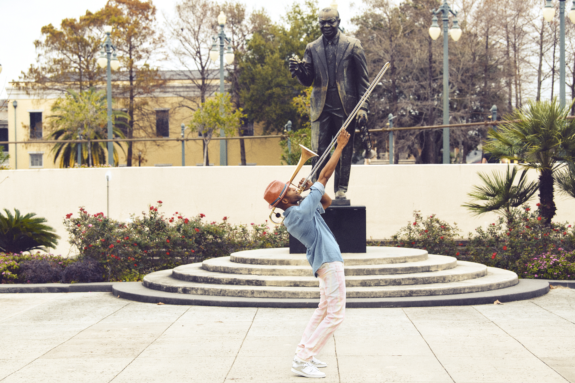 Trombone Shorty wearing 7 for all mankind and Ovadia at Louis Armstrong Park in New Orleans