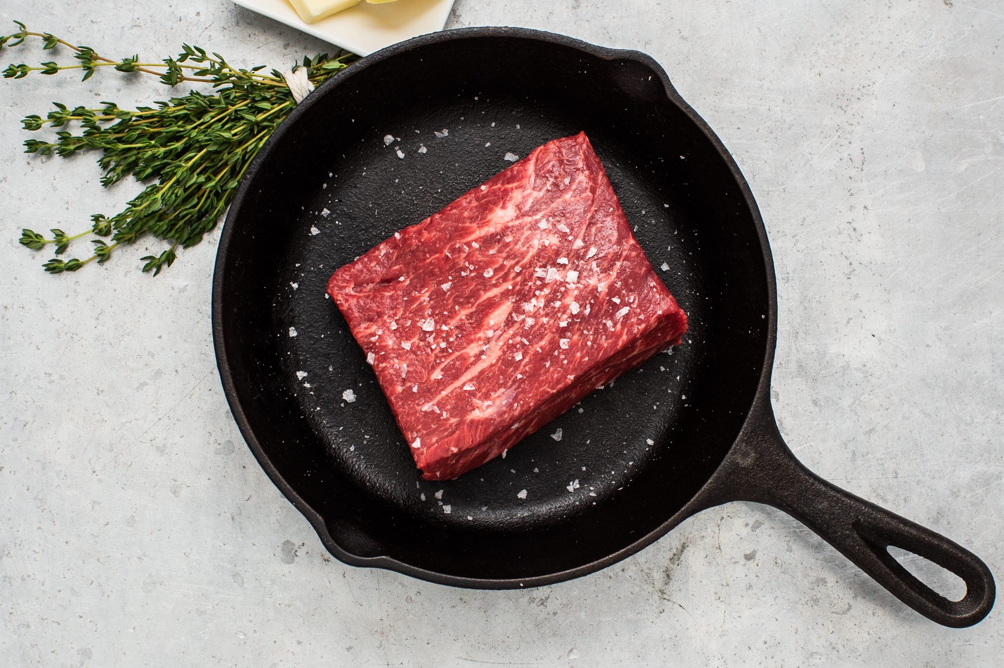 A Denver steak from Porter Road sitting in a skillet waiting to sizzle