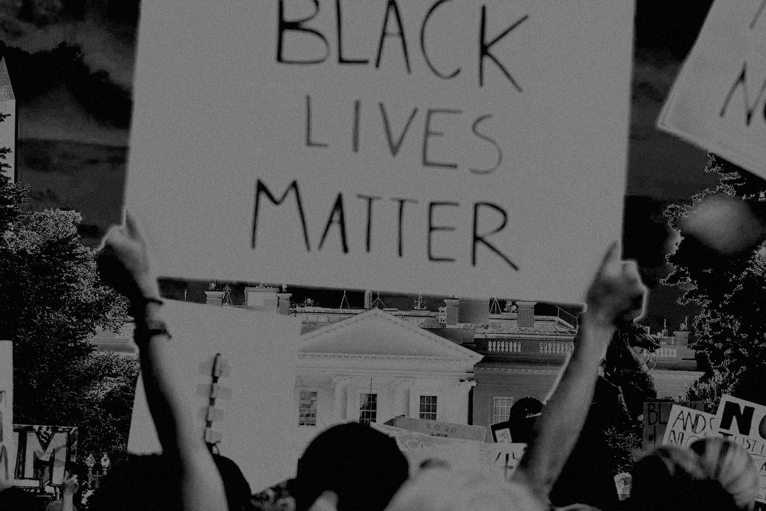 Demonstrators protesting the death of George Floyd hold up placards up near the White House.