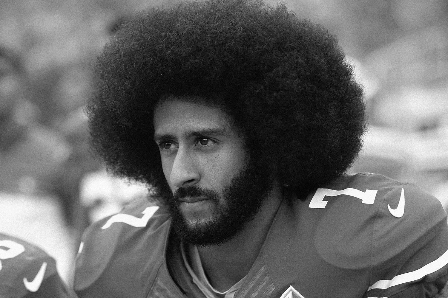 Colin Kaepernick kneels before a game