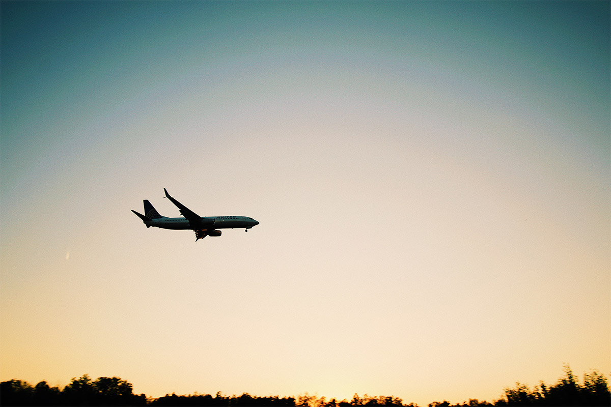 A silhouetted airplane flying