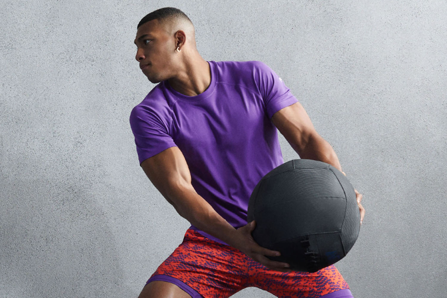 a model in Fabletics gear throwing a ball