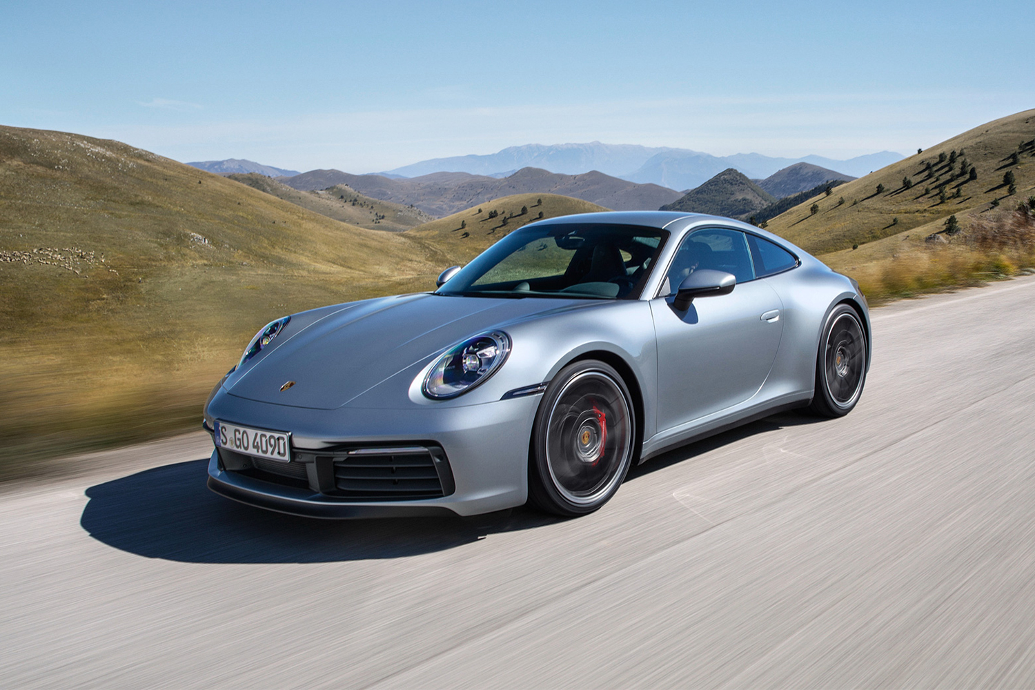 2018 Porsche 911 Carrera 4S sports car in silver driving through the hills