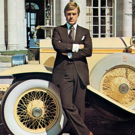 Robert Redford as Jay Gatsby in the 1974 movie adaptation of "The Great Gatsby" stands next to a yellow Rolls-Royce