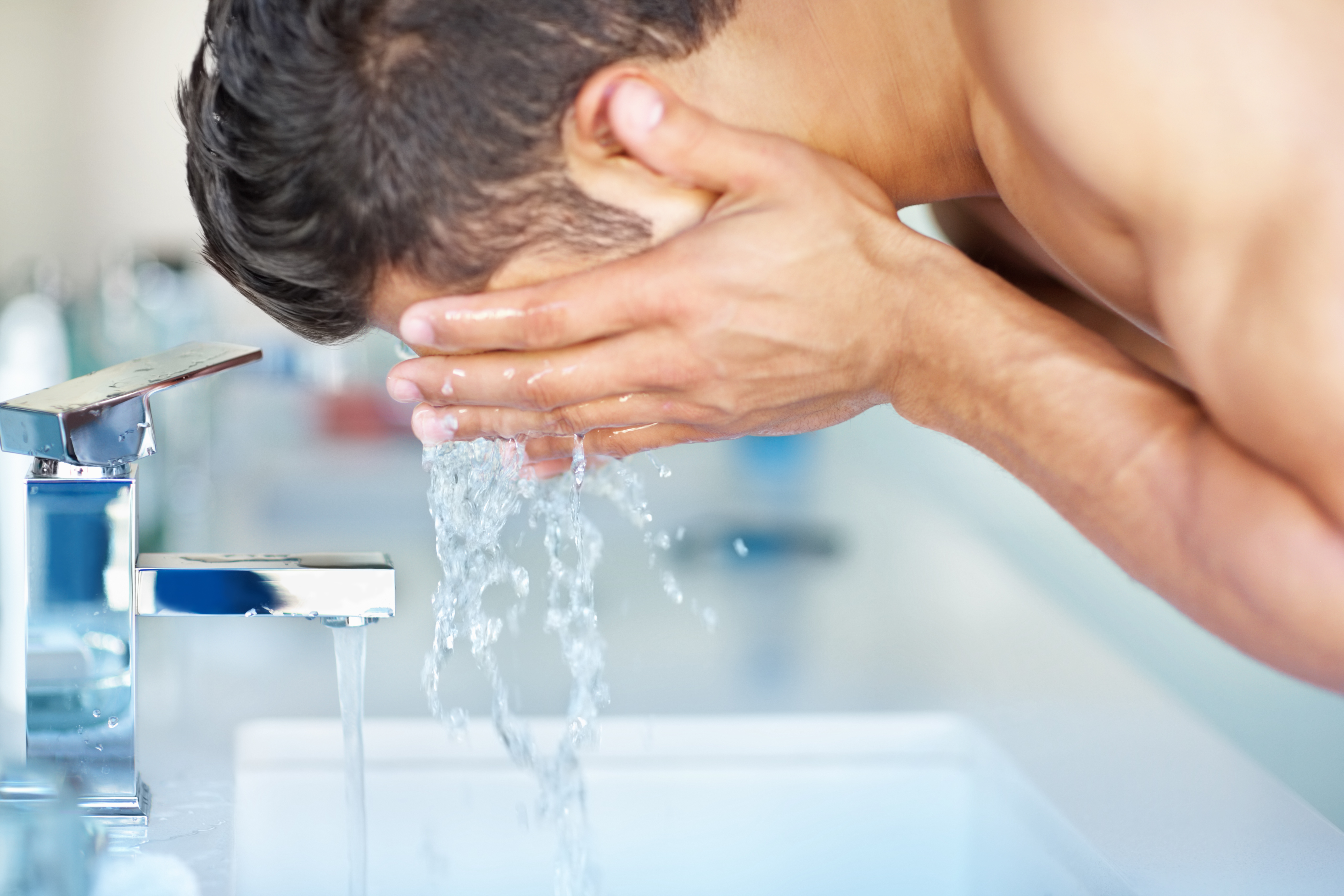 man washing face