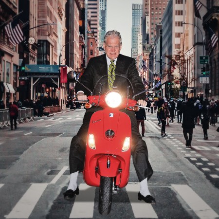 David Letterman riding a Vespa motor scooter in New York City