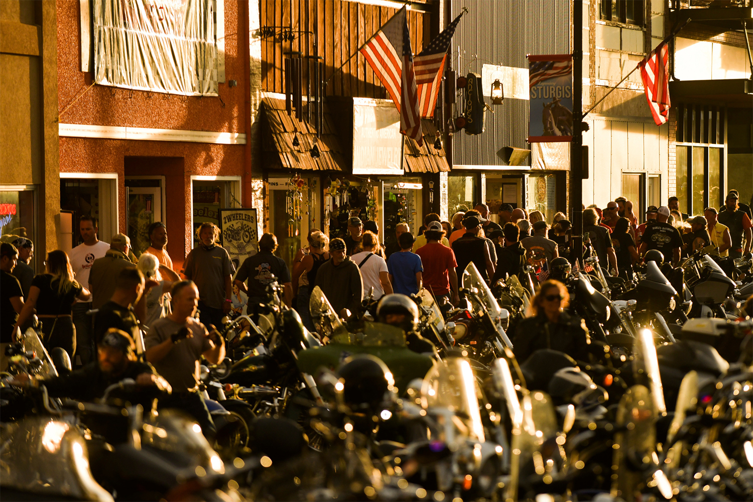 People walk along Main Street during the 80th Annual Sturgis Motorcycle Rally in Sturgis, South Dakota on August 8, 2020