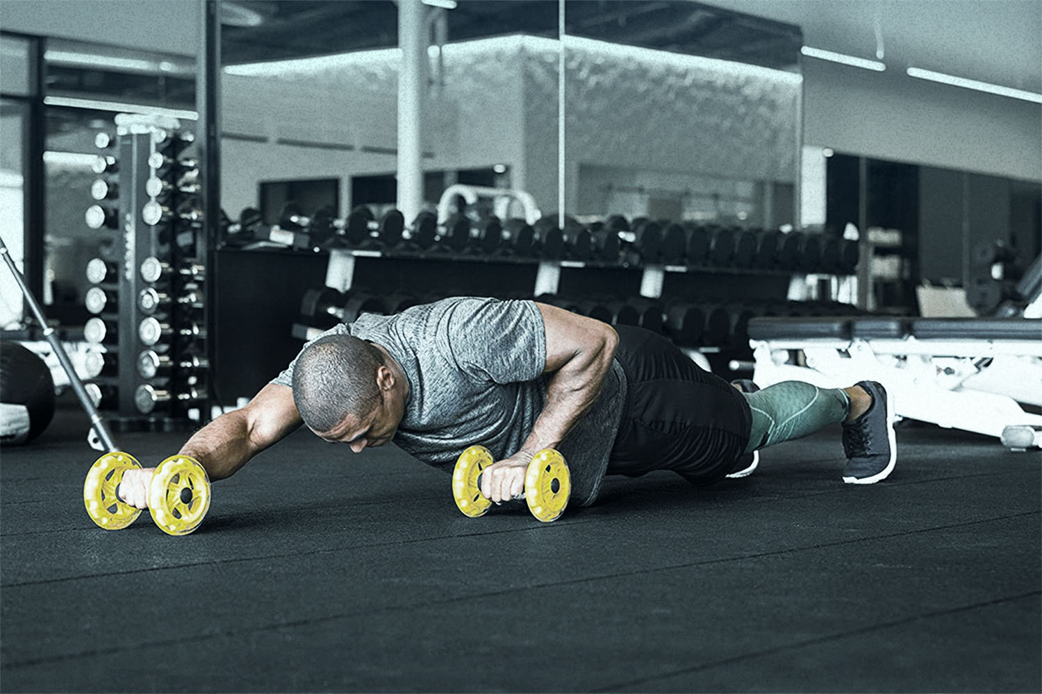 man working out with core wheels