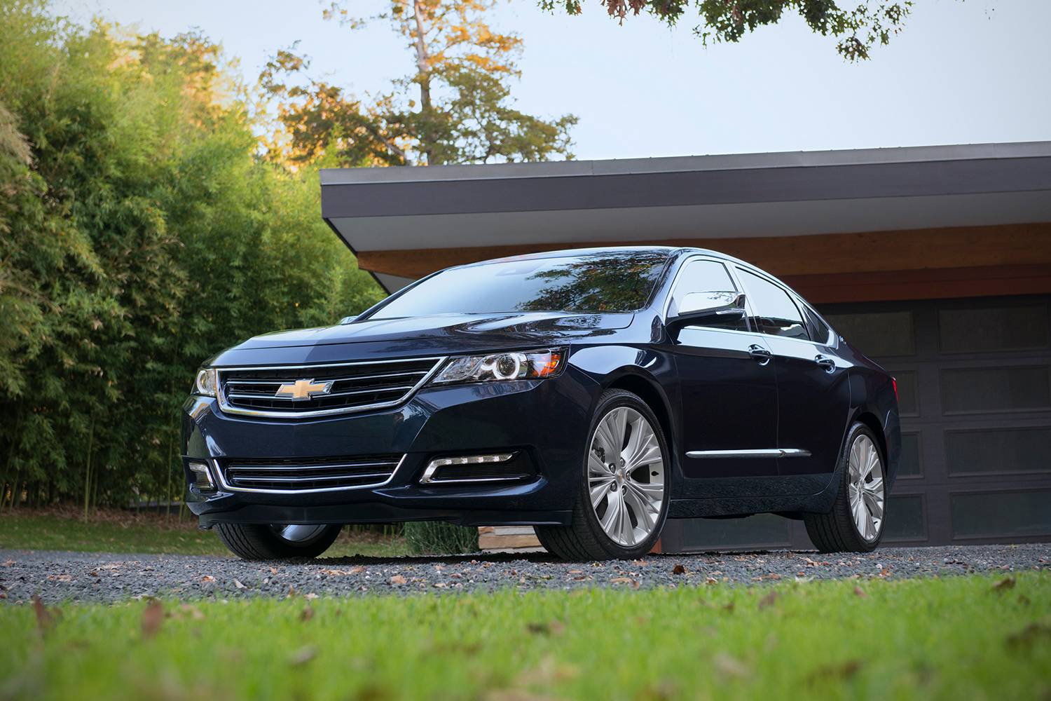 A 2018 Chevrolet Impala car sitting in the driveway of a house