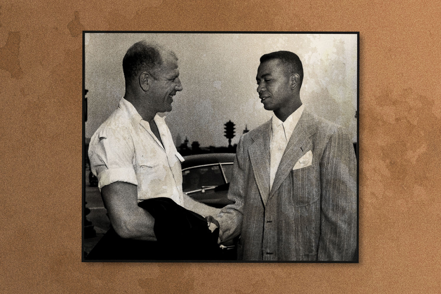 Doby shakes hands with his new boss, President Bill Veeck of the Cleveland Indians', after arriving in Chicago