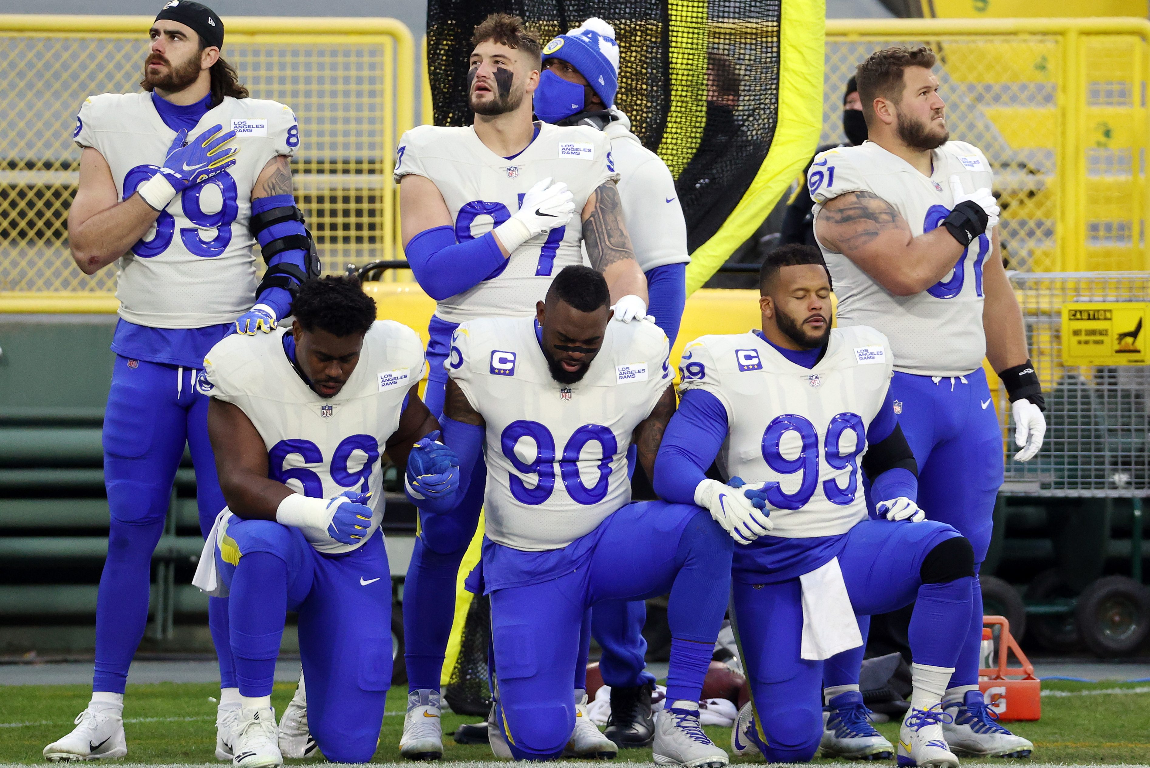 Members of the Los Angeles Rams kneel during the national anthem