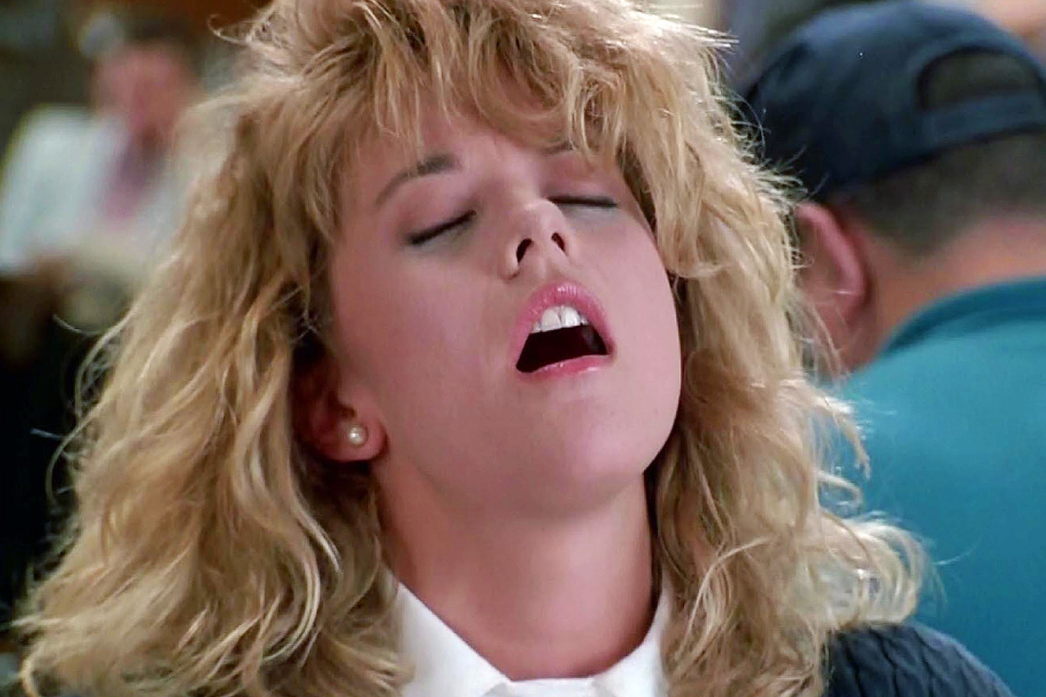 still from When Harry Met Sally shows Meg Ryan playing Sally Allbright faking an orgasm