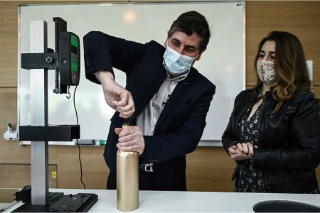 Philippe Darriet, Director of the Oenology Research Unit Institute of Vines, Science and Wine (ISVV) opens an "anonymised" bottle of Petrus before being blindly presented for comparaison tasting, at the University of Bordeaux Institut des Sciences de la Vigne et du Vin (Institute of Vine & Wine Science) in Villenave-d'Ornon, on the outskirts of Bordeaux, southwestern France, on March 1, 2021. - It has come back from afar after a trip in the extreme conditions of space: in Bordeaux, bottles of Petrus and vine shoots are analysed by researchers who are developing an experiment on micro-gravity, the accelerating potential of more agriculture "resilient" on earth.