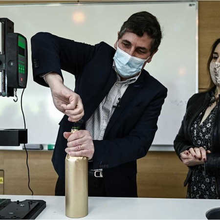 Philippe Darriet, Director of the Oenology Research Unit Institute of Vines, Science and Wine (ISVV) opens an "anonymised" bottle of Petrus before being blindly presented for comparaison tasting, at the University of Bordeaux Institut des Sciences de la Vigne et du Vin (Institute of Vine & Wine Science) in Villenave-d'Ornon, on the outskirts of Bordeaux, southwestern France, on March 1, 2021. - It has come back from afar after a trip in the extreme conditions of space: in Bordeaux, bottles of Petrus and vine shoots are analysed by researchers who are developing an experiment on micro-gravity, the accelerating potential of more agriculture "resilient" on earth.