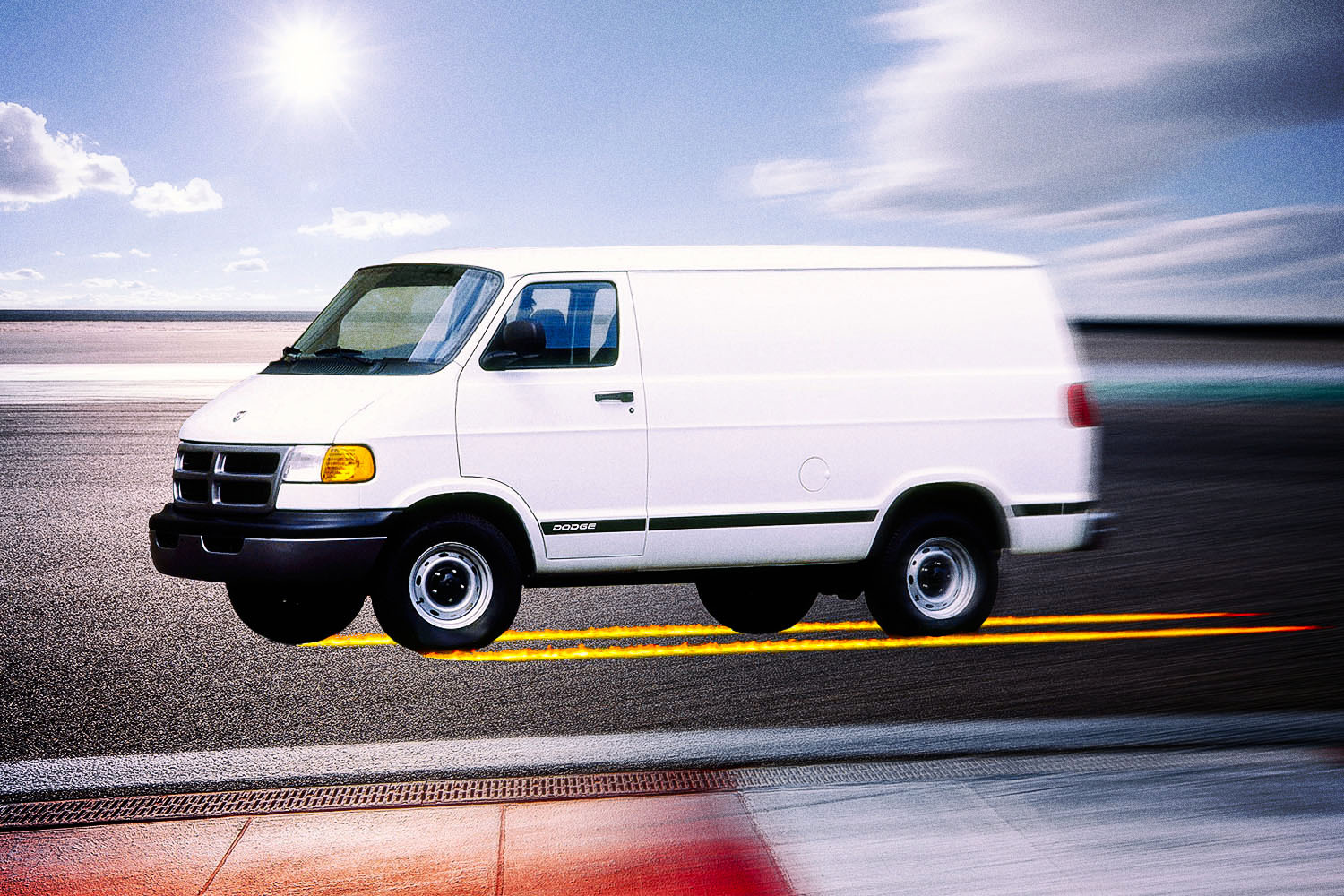 A white Dodge B-series van racing down a track with flames running behind