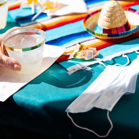 A mask is left on a table next to a margarita at Moldaw Residences in Palo Alto, Calif., on Monday, Feb. 22, 2021.