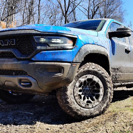 A blue 2021 Ram 1500 TRX off-road pickup truck after driving through the mud