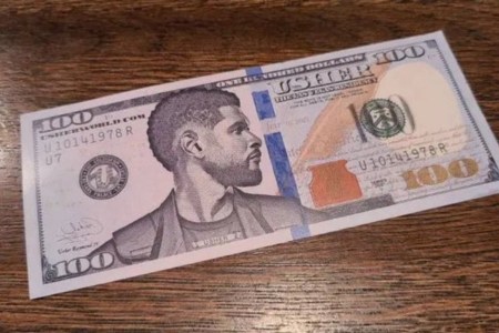 A $100 bill with Usher's face on it