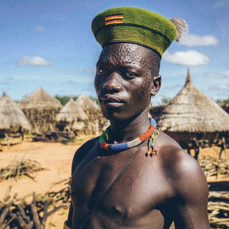 a karamajong man with scars on his face forming a pattern as a beauty and identity sign