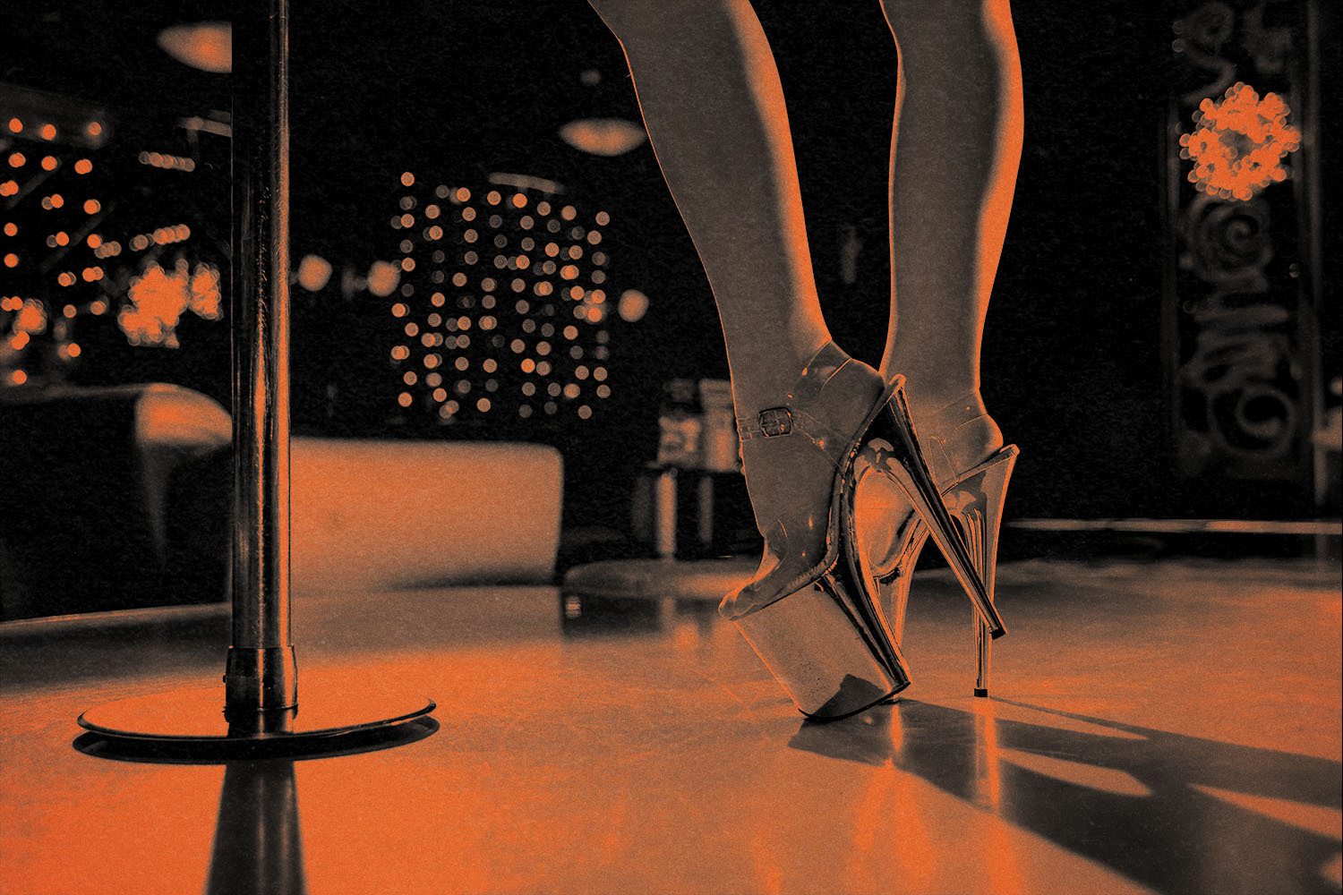 woman wearing platform heels stands near stripper pole