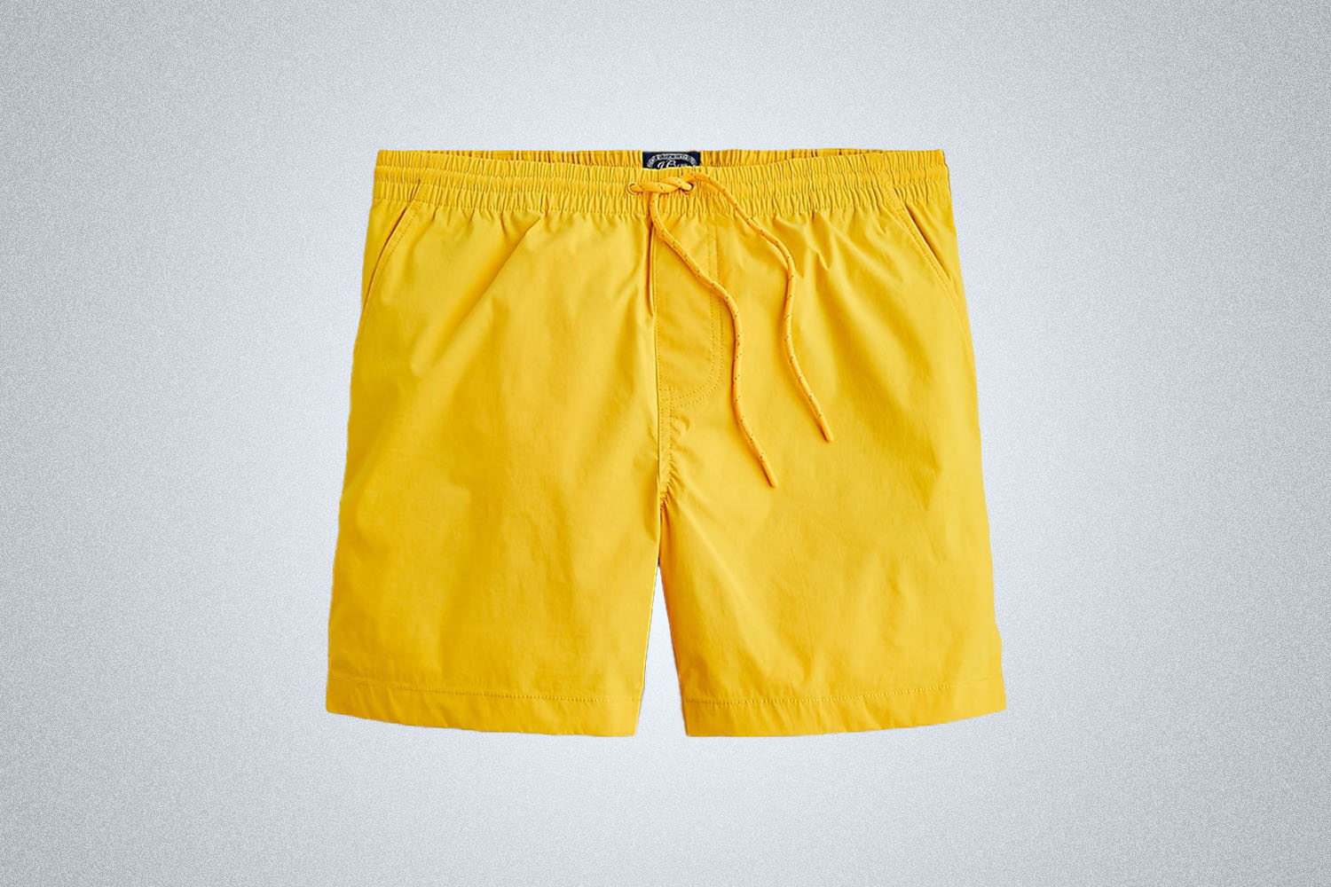 a pair of nylon shorts on a grey background