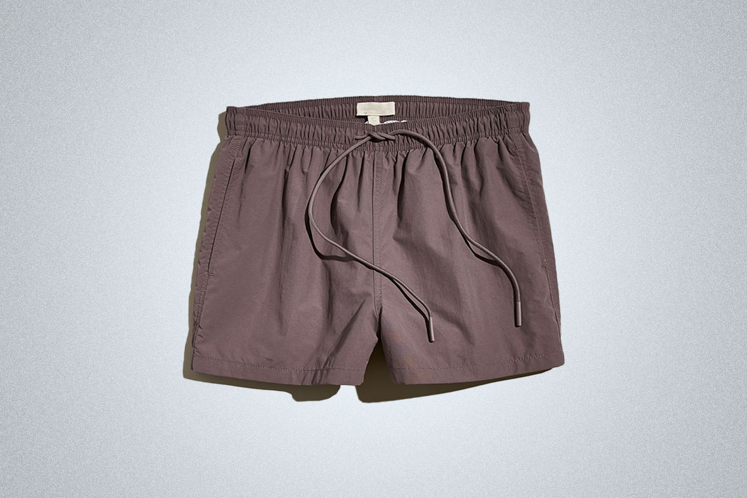 a pair of nylon shorts on a grey background