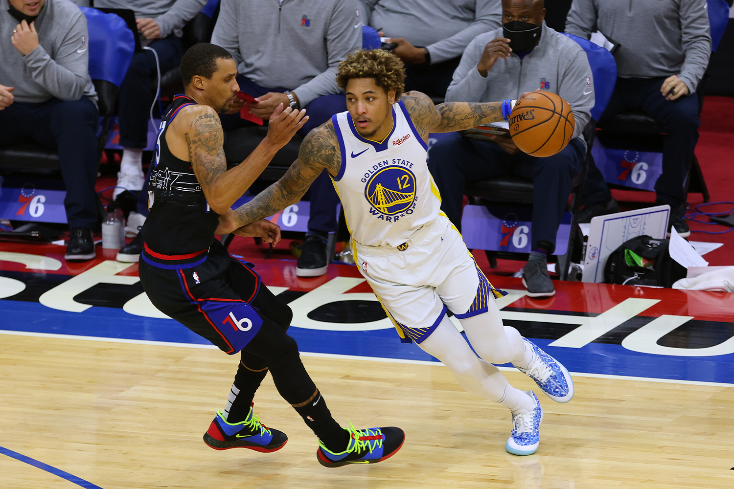 Kelly Oubre Jr. #12 of the Golden State Warriors in action against George Hill #33 the Philadelphia 76ers 