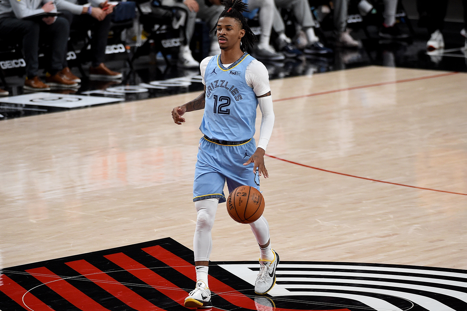 Ja Morant #12 of the Memphis Grizzlies brings the ball up the court during the first half of the game against the Portland Trail Blazers