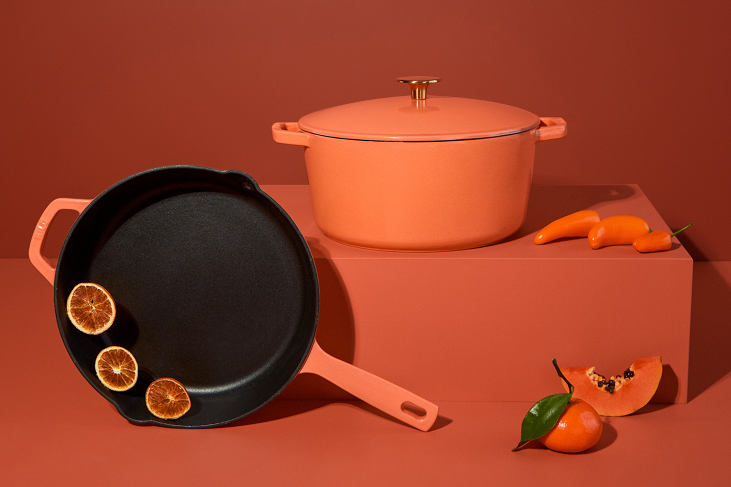 A Milo cast iron skillet and enameled Dutch oven in the color terracotta