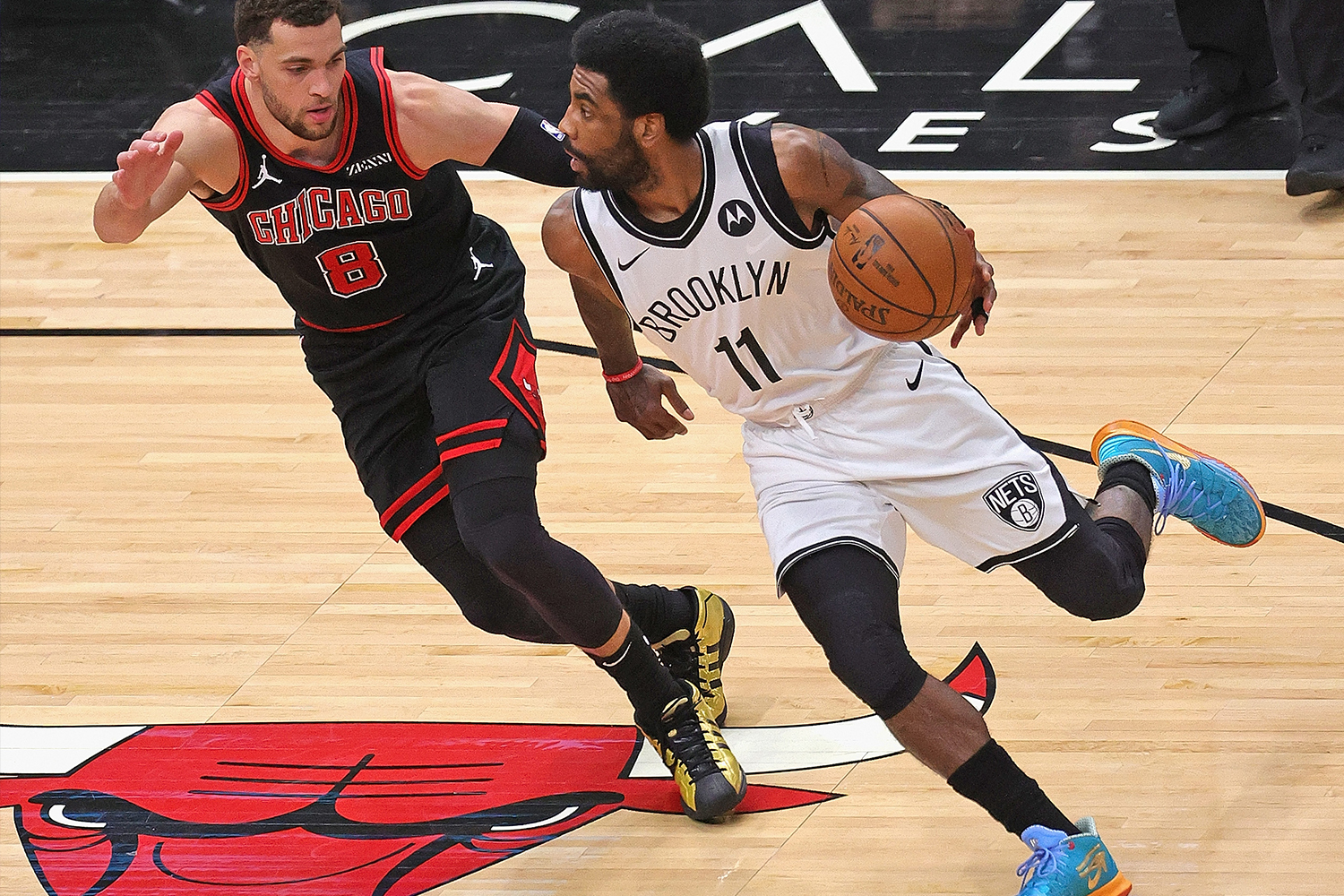 Kyrie Irving #11 of the Brooklyn Nets drives against Zach LaVine #8 of the Chicago Bulls