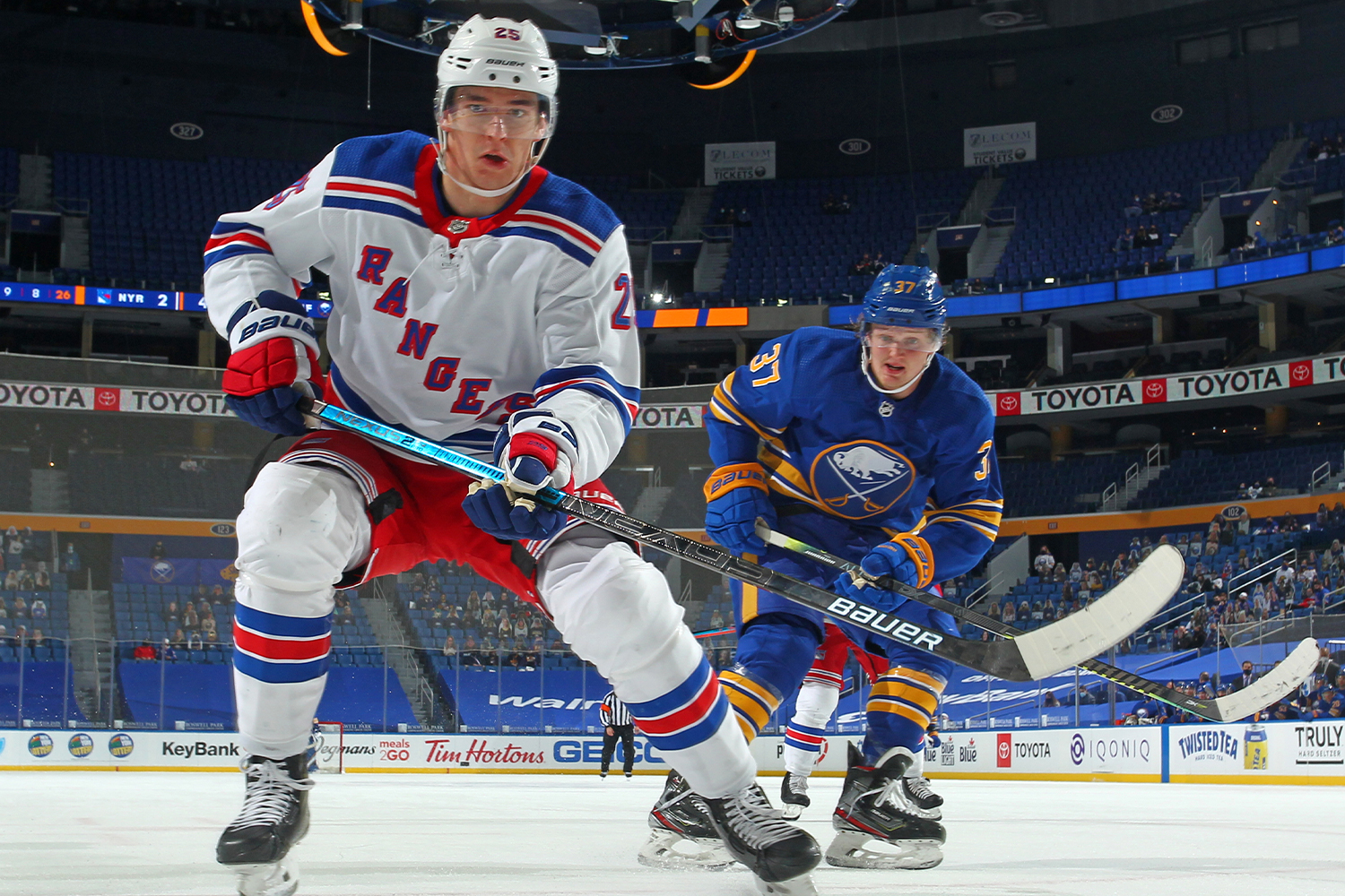 Libor Hajek #25 of the New York Rangers and Casey Mittelstadt #37 of the Buffalo Sabres follow the puck during an NHL game on April 3, 2021