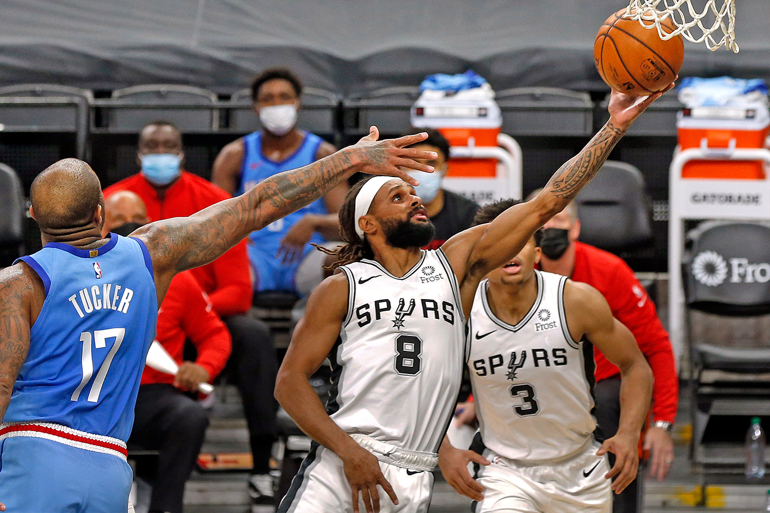 Patty Mills #8 of the San Antonio Spurs stretches to the basket past PJ Tucker #17 of the Houston Rockets