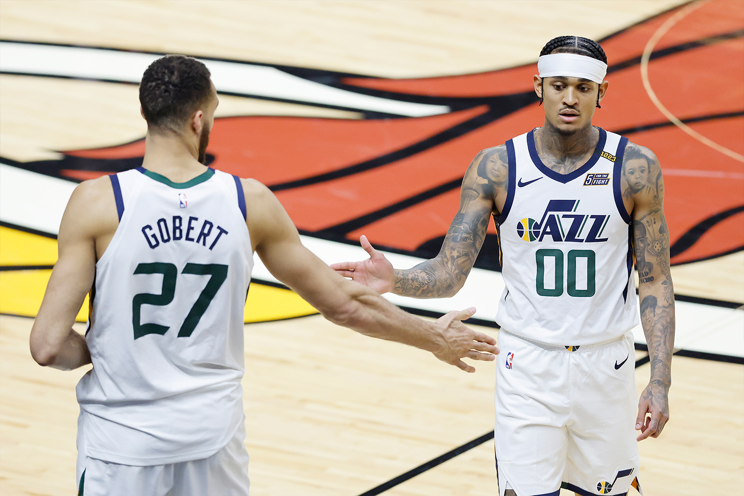 Rudy Gobert #27 and Jordan Clarkson #00 of the Utah Jazz high five against the Miami Heat