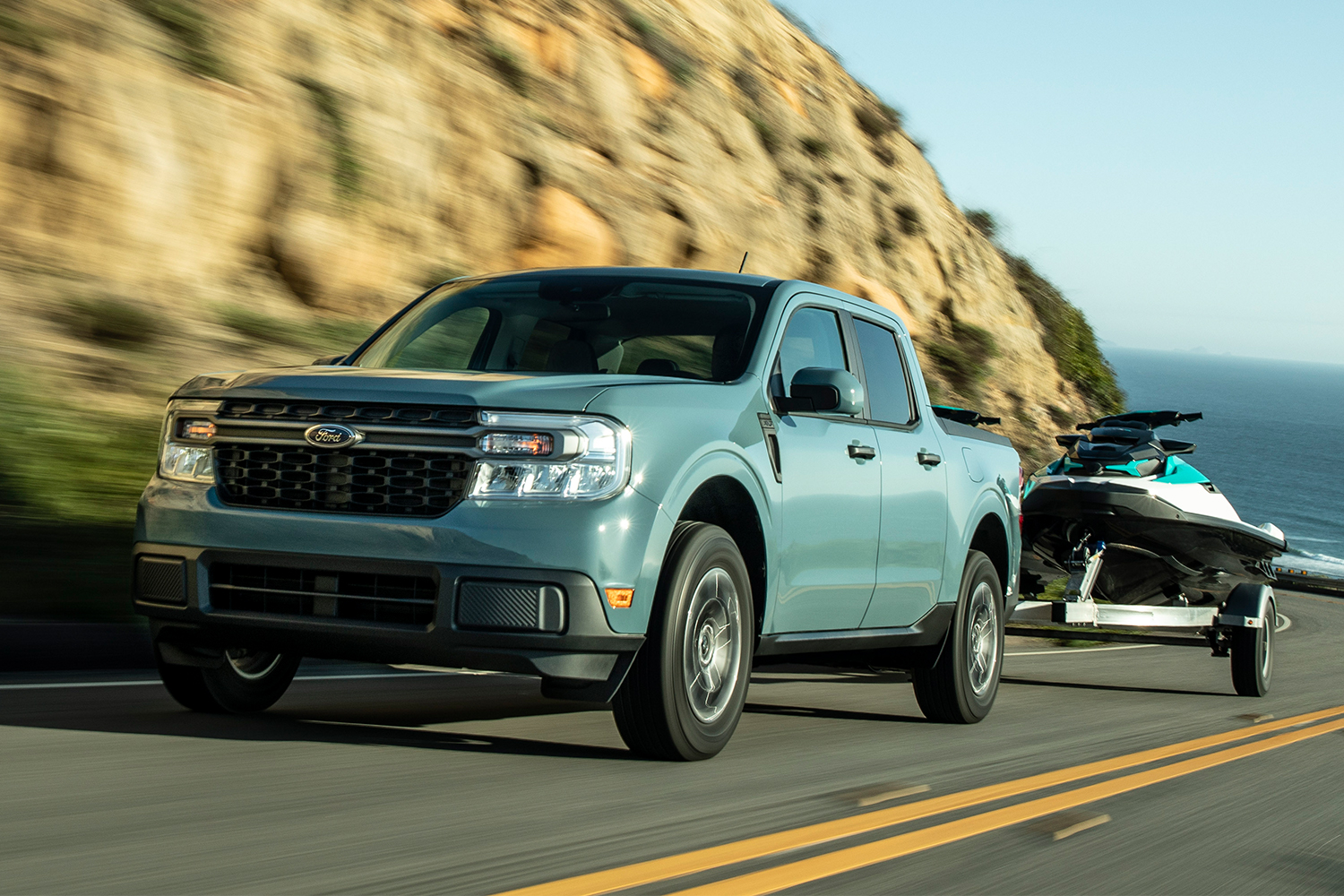 The 2022 Ford Maverick compact pickup truck towing a jet ski