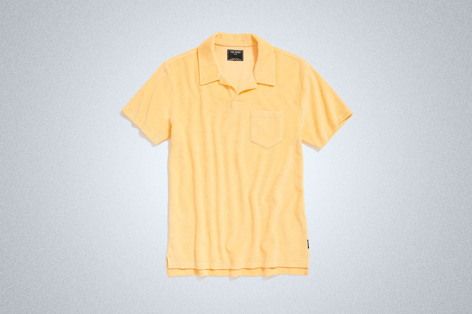 a yellow terry polo from Todd Snyder on a grey background