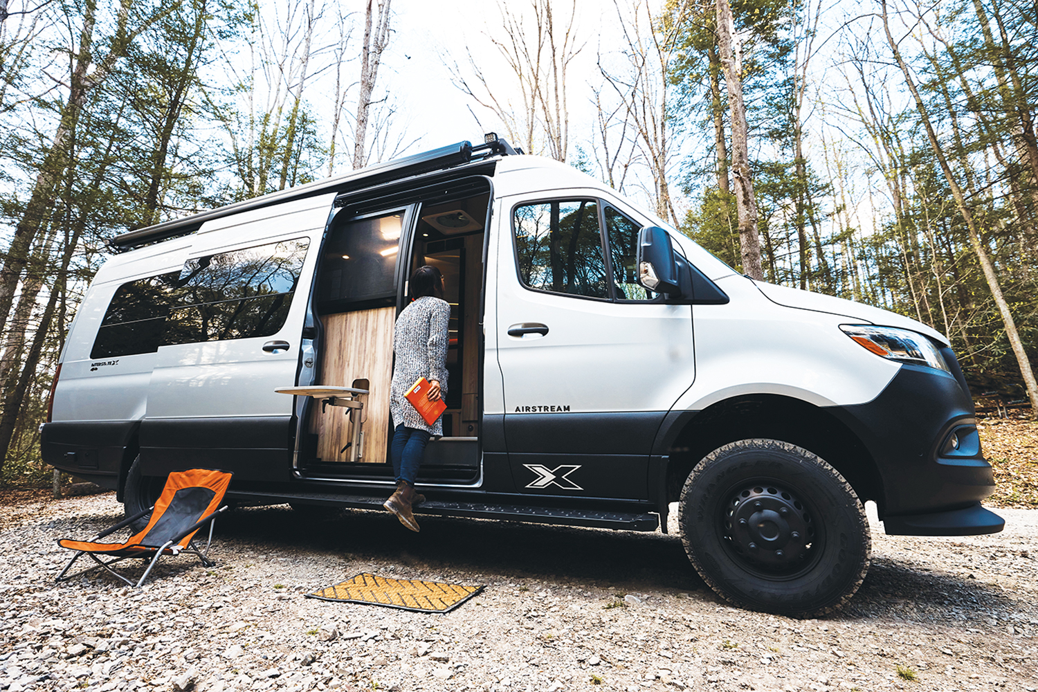 A person stepping into the Airstream Interstate 24X adventure van