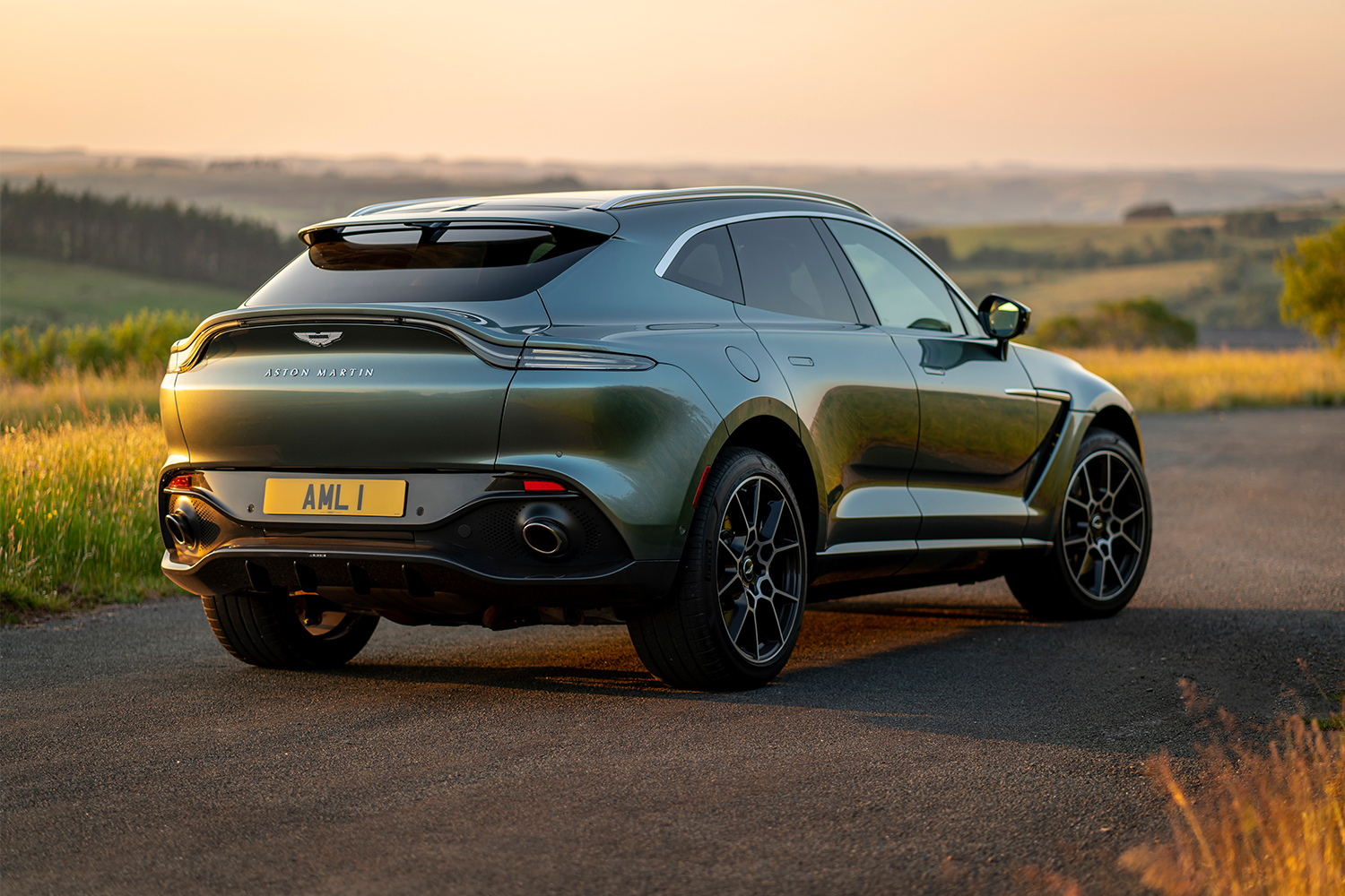 The back end of a 2021 Aston Martin DBX SUV in the country